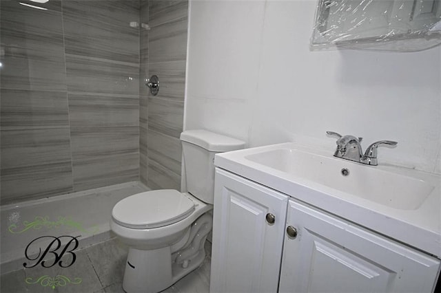 bathroom with vanity, tile patterned floors, toilet, and a shower