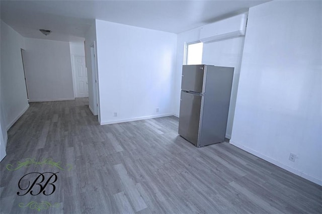 interior space featuring a wall mounted air conditioner and dark wood-type flooring