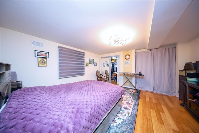 bedroom with hardwood / wood-style floors and a closet