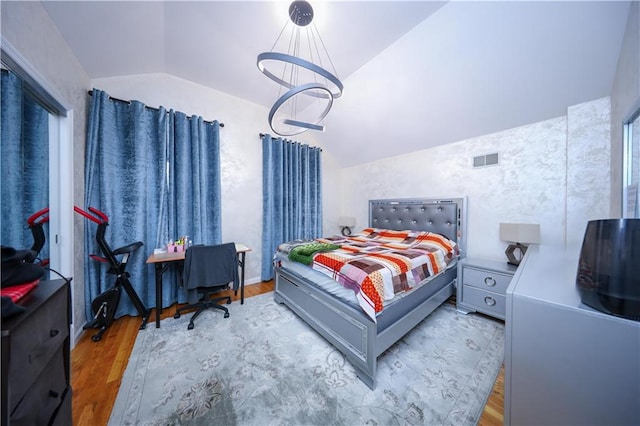 bedroom featuring hardwood / wood-style floors and lofted ceiling