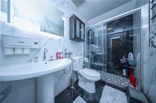 bathroom featuring sink, toilet, walk in shower, and tile walls