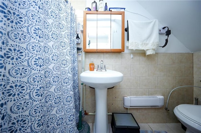 bathroom with tile walls and toilet