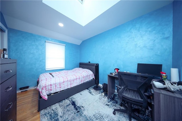 bedroom featuring hardwood / wood-style flooring and vaulted ceiling