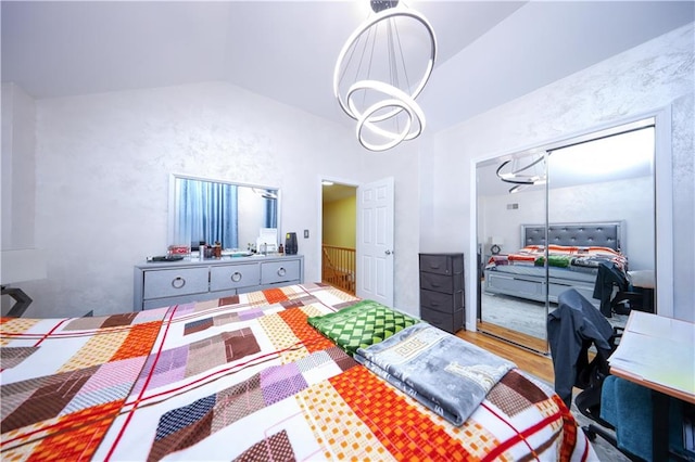 bedroom with wood-type flooring and vaulted ceiling