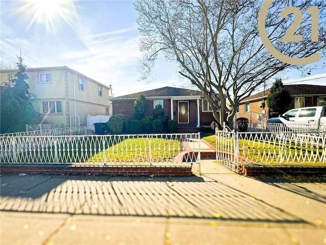 view of front of house with a fenced front yard and brick siding