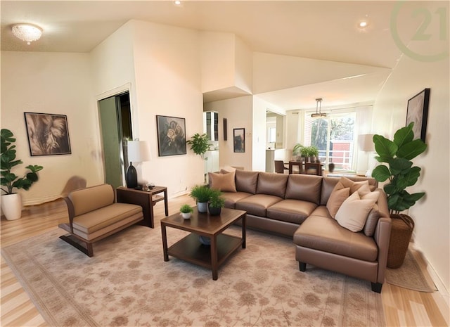 living room with lofted ceiling and light wood-style flooring