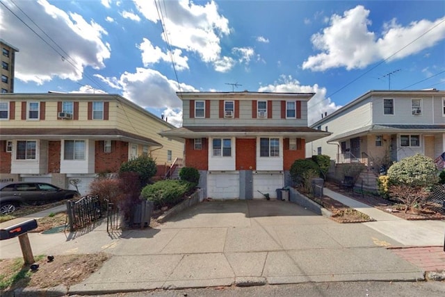 958 Clove Rd, Staten Island, NY 10301 - view of front of property featuring driveway, brick siding, a garage, and fence
