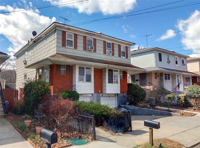 view of front of house with a garage and cooling unit