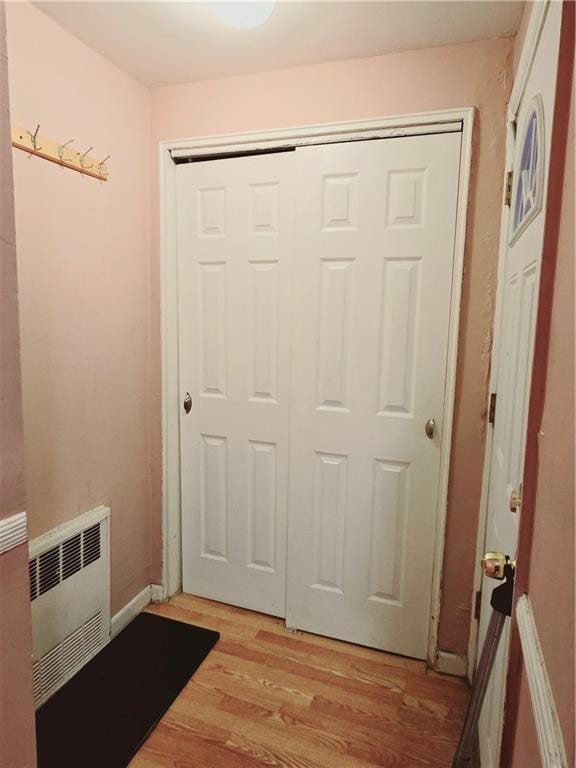 doorway featuring radiator heating unit and light hardwood / wood-style floors