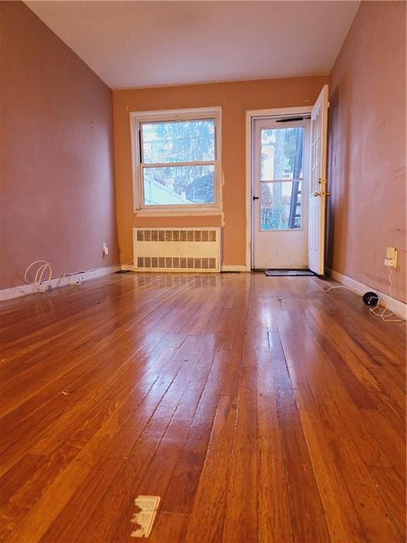 interior space featuring plenty of natural light, wood-type flooring, and radiator