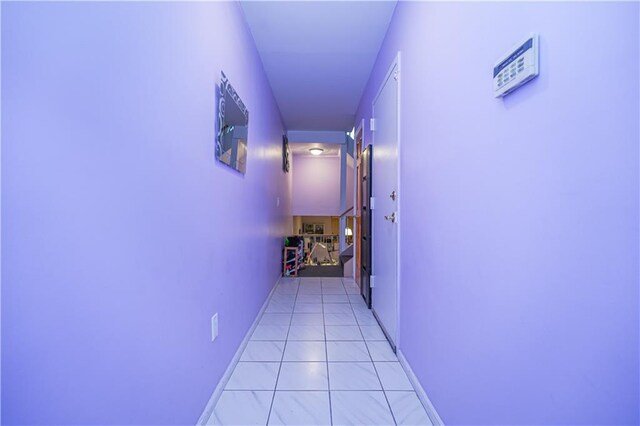 corridor featuring light tile patterned floors