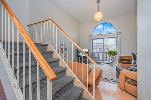 stairs featuring hardwood / wood-style floors