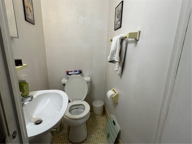 bathroom with tile patterned floors, sink, and toilet