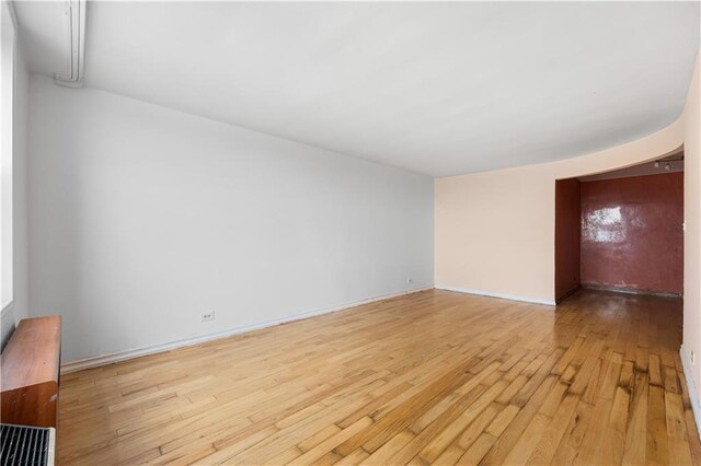 empty room with light hardwood / wood-style flooring