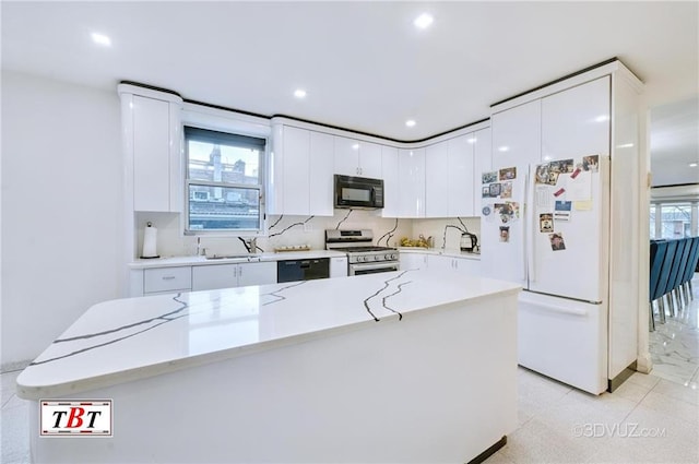 1801 E 7th St, Brooklyn, NY 11223 - kitchen featuring black appliances, light countertops, white cabinets, recessed lighting, and a center island