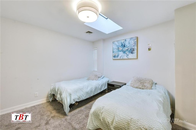 carpeted bedroom featuring a skylight