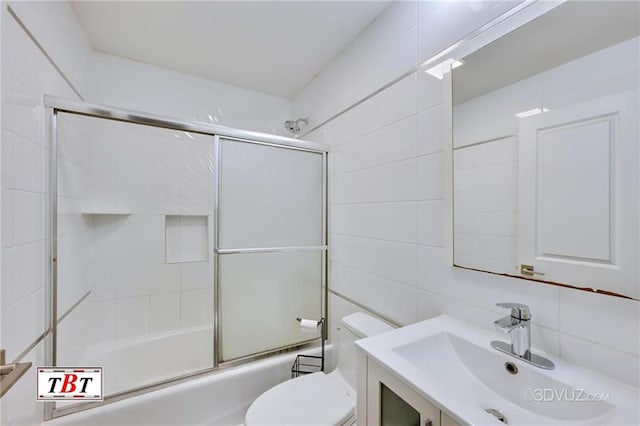 1801 E 7th St, Brooklyn, NY 11223 - full bathroom featuring tile walls, shower / bath combination with glass door, and vanity