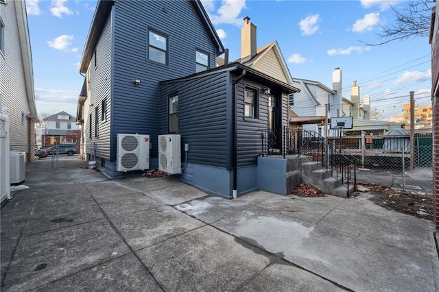 back of house with cooling unit and a patio