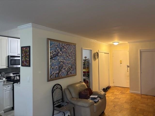 living room featuring crown molding and light parquet flooring