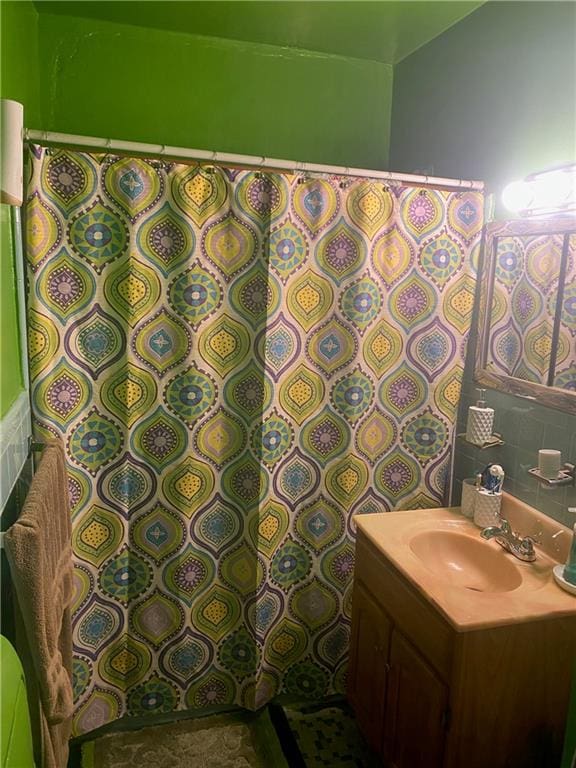 bathroom featuring vanity and tasteful backsplash