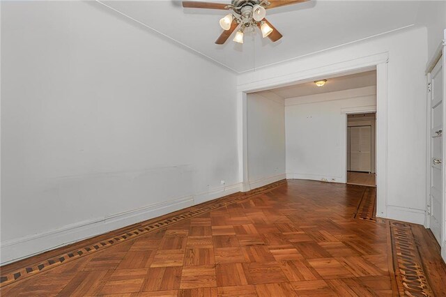 unfurnished room featuring parquet floors and ceiling fan