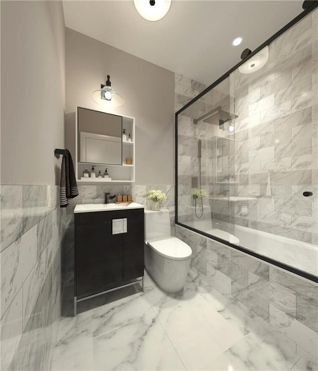 full bathroom with toilet, tiled shower / bath combo, marble finish floor, vanity, and tile walls