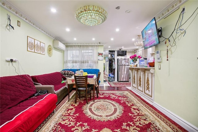 living room with a wall mounted air conditioner and hardwood / wood-style flooring