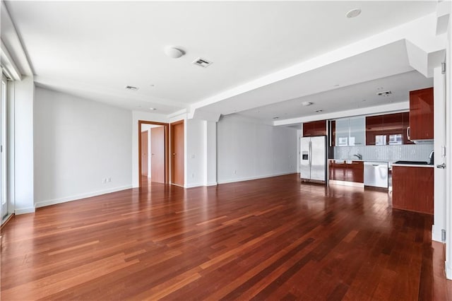 unfurnished living room with dark hardwood / wood-style floors