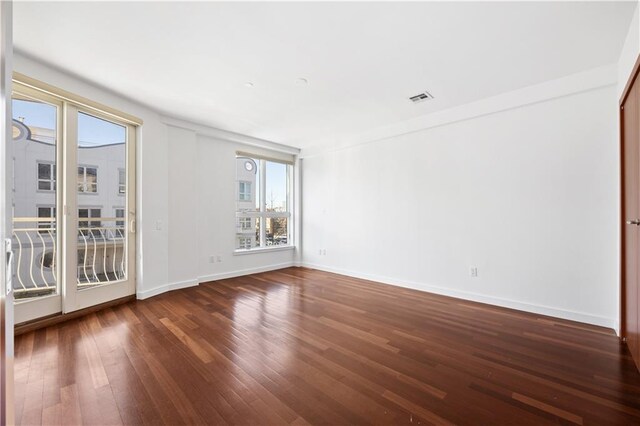 empty room with dark hardwood / wood-style floors