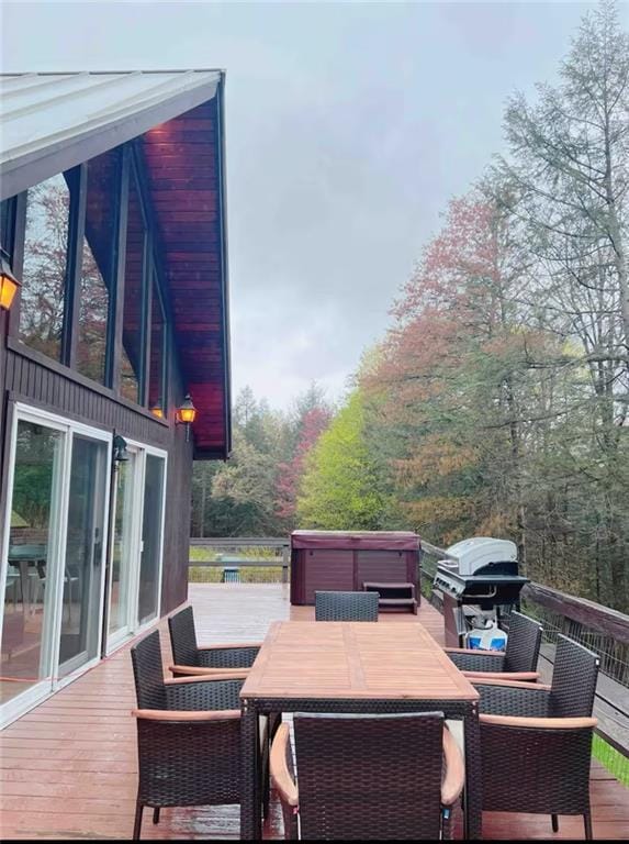 deck featuring grilling area and a hot tub