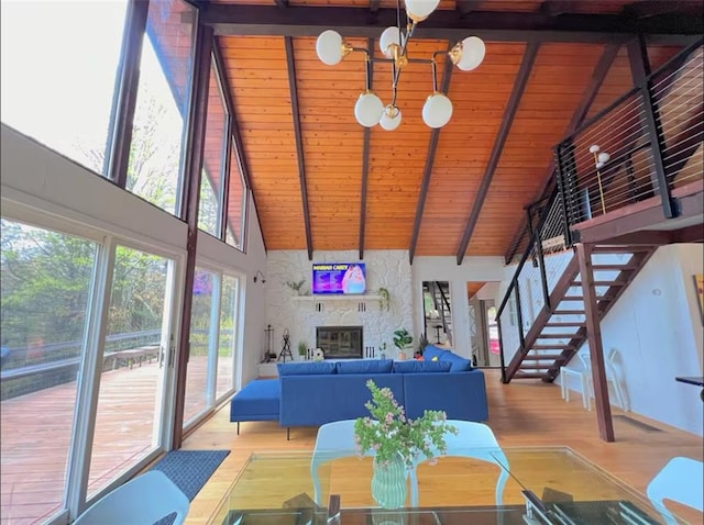 dining area featuring beam ceiling, light wood-type flooring, wood ceiling, and high vaulted ceiling