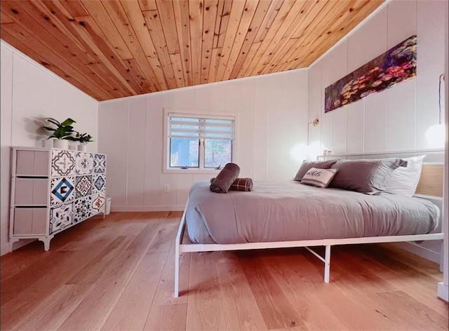 bedroom with light hardwood / wood-style floors, wood ceiling, and vaulted ceiling