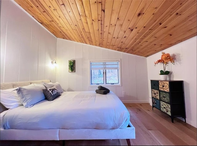 bedroom featuring wooden ceiling, lofted ceiling, and light wood-type flooring