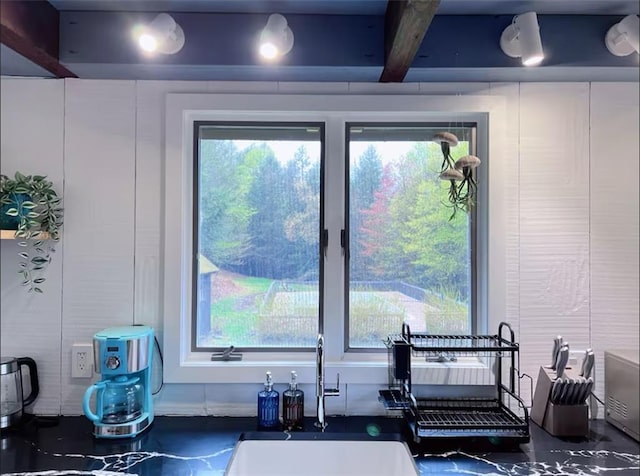 interior space with sink and beam ceiling