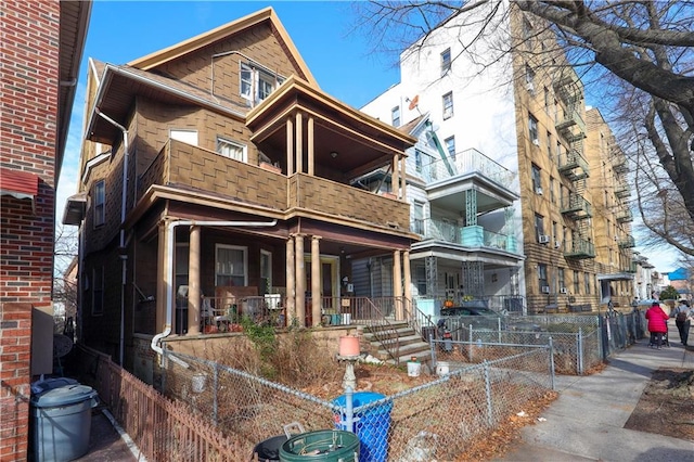 view of front of house with covered porch and a balcony