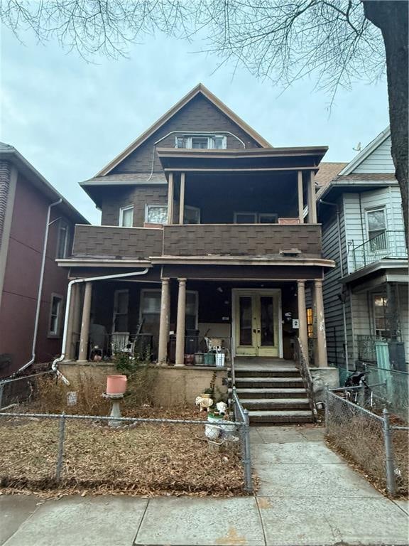 view of front of home with a porch and a balcony