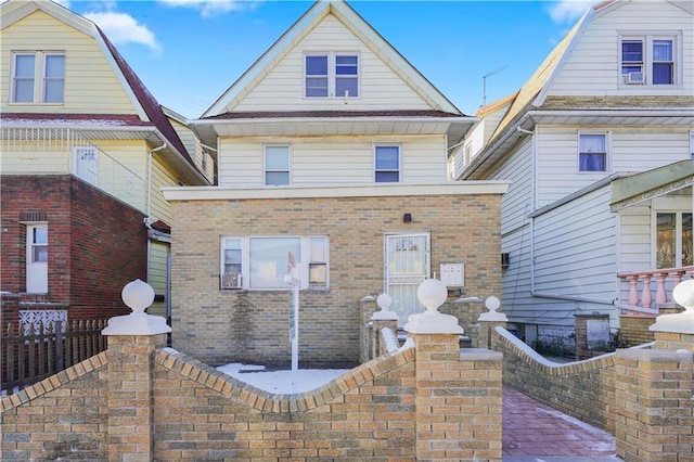 view of front of property with a fenced front yard and brick siding