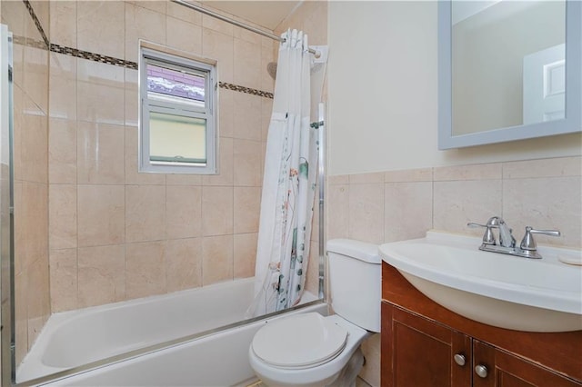 full bath featuring toilet, shower / bath combo, vanity, and tile walls