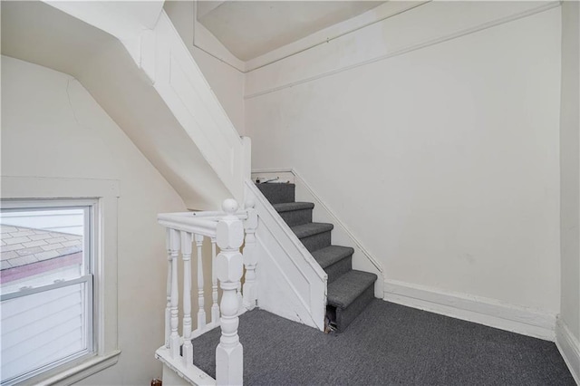 stairs with carpet, a wealth of natural light, and baseboards