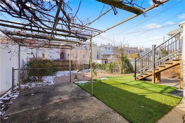 view of yard with fence and stairway