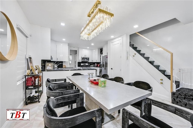 dining room with baseboards, stairway, and recessed lighting