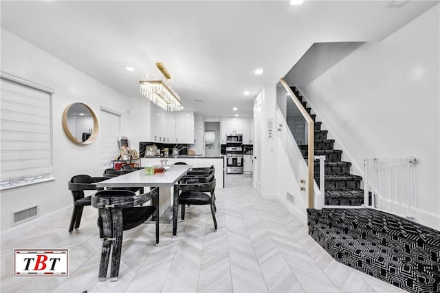 dining area with recessed lighting, visible vents, stairway, and baseboards