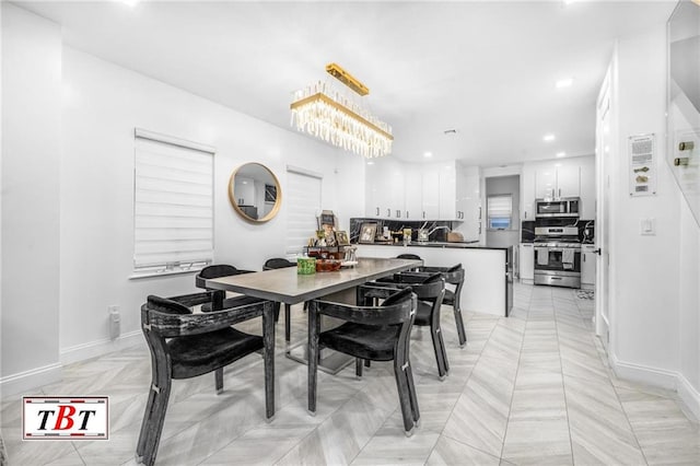 dining space with recessed lighting and baseboards