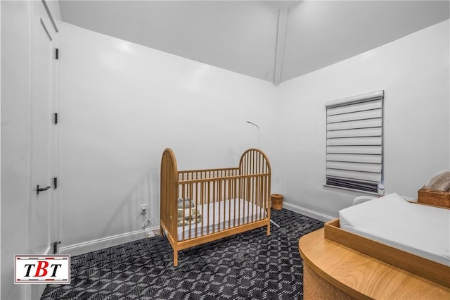 bedroom with carpet floors, a nursery area, and baseboards