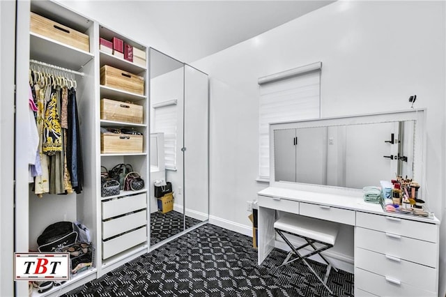 office with dark colored carpet and baseboards