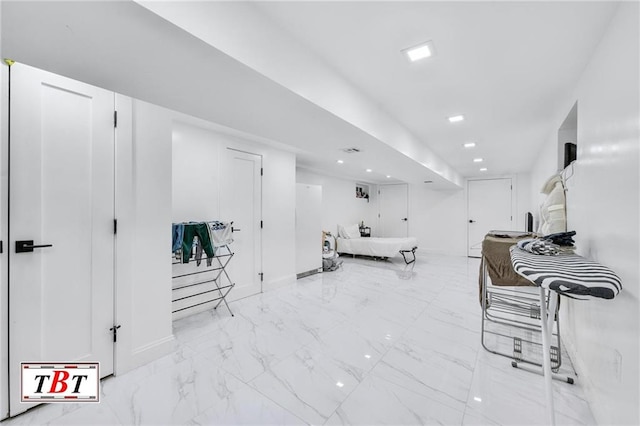 interior space with marble finish floor and recessed lighting