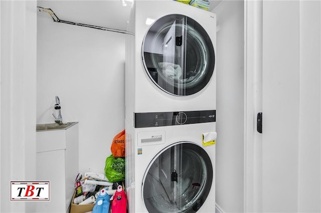 washroom featuring stacked washer and clothes dryer