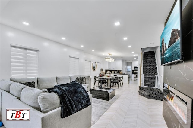 living room with stairs and recessed lighting