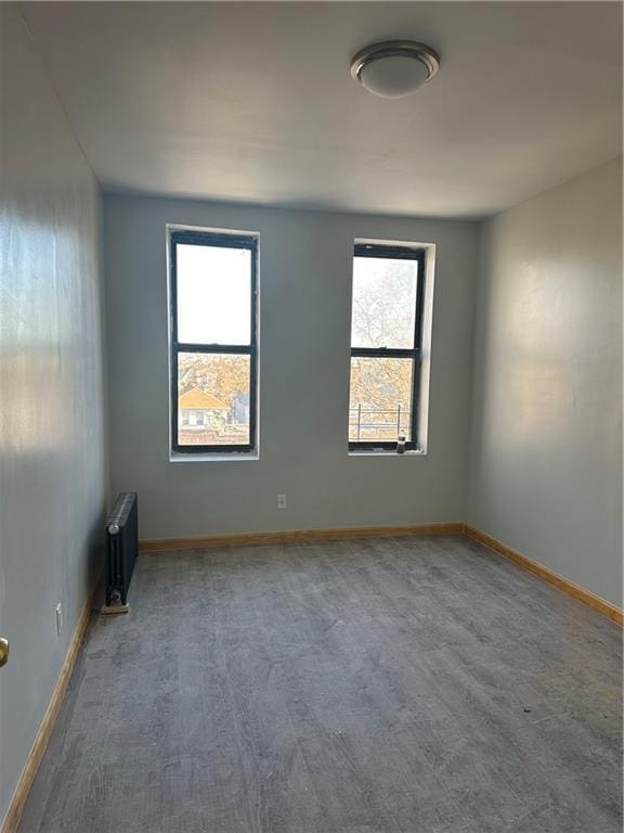 spare room featuring radiator heating unit