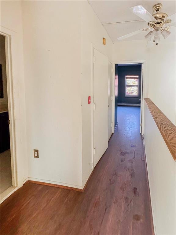 corridor featuring dark hardwood / wood-style floors and vaulted ceiling